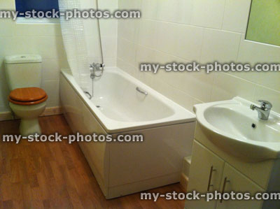 Stock image of stylish white bathroom suite, sink and modern toilet
