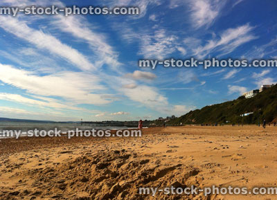 Stock image of golden sandy beach with stunning blue cloudy sky
