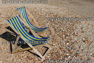 Stock image of deck chairs on pebbles on English beach