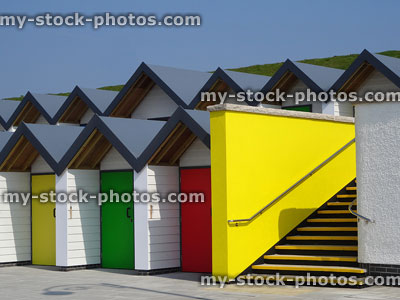 Stock image of white beach huts on promenade, canary yellow wall