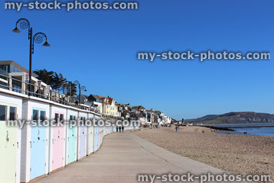 Stock image of pastel beach huts on promenade in Lyme Regis