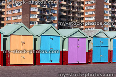 Stock image of orange, blue and purple beach huts in Brighton