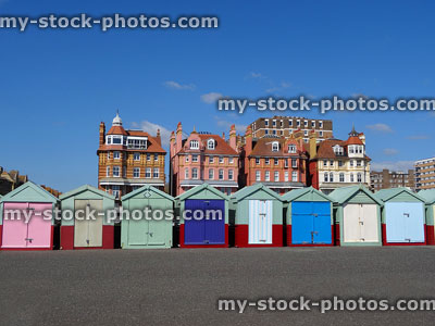 Stock image of rainbow coloured beach huts on Brighton seaside promenade