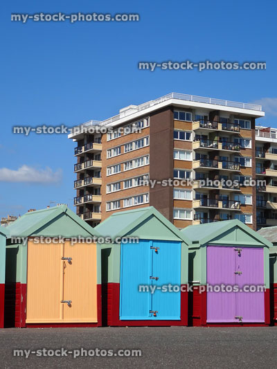 Stock image of beach huts and blocks of flats on Brighton seaside promenade
