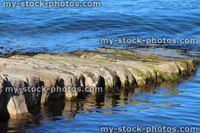 Stock image of stone jetty by beach / seaside landing stage / sea