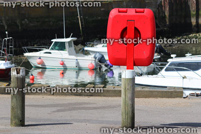 Stock image of containerised lifering / red lifebuoy donut ring by marina