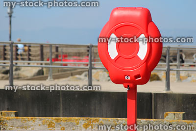 Stock image of lifering donut lifesaver at seaside, by harbour / sea