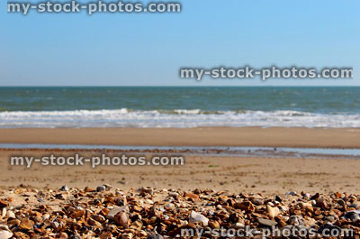 Stock image of pebbles, sand and sea on beach, English seaside