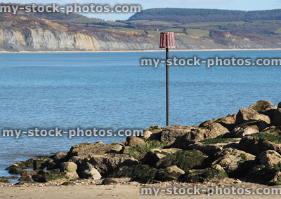 Stock image of rocks on beach, coastal erosion management, rock armour riprap