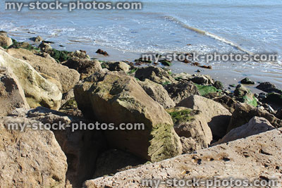Stock image of rock revetment on beach, controlling coastal erosion sand dune
