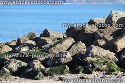 Stock image of natural sea defence, rock armour on beach, coastal management