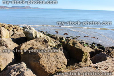 Stock image of rock armour sea defence on beach, preventing coastal erosion