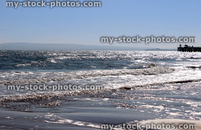 Stock image of sparkling sea and distant pier at Bournemouth, England