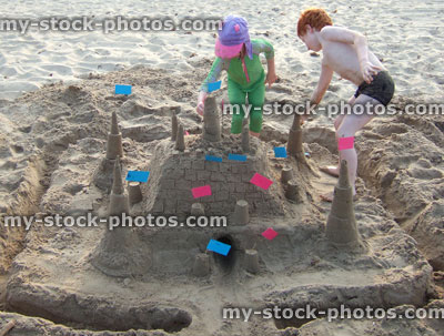 Stock image of children busy constructing a sandcastle on a beach at Swanage