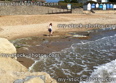 Stock image of young girl at beach paddling in the sea