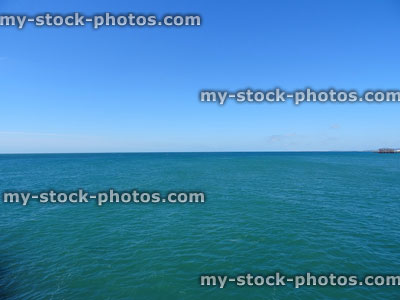Stock image of blue sea / sky horizon, coastal-panorama with old Brighton-pier