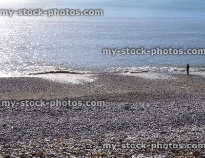 Stock image of sparkling blue waves and pebble beach, seaside view