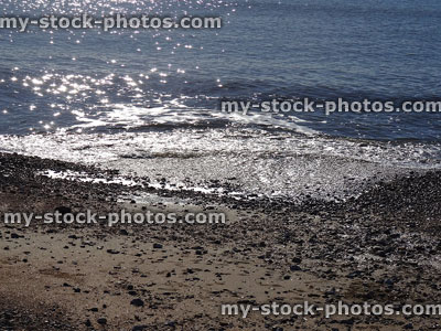 Stock image of sparkling / glistening sea waves in sun, seaside beach