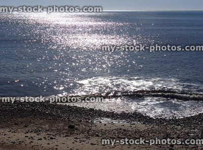 Stock image of sunny seaside backlit waves, sparkling and glistening sea