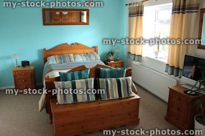 Stock image of colour coordinated bedroom suite with pine bed furniture
