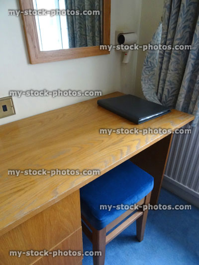 Stock image of wooden work desk in bedroom, stool, chair, office space