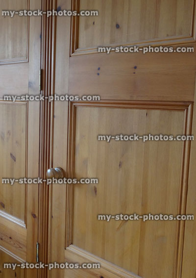 Stock image of wooden pine wardrobe doors in bedroom, waxed finished