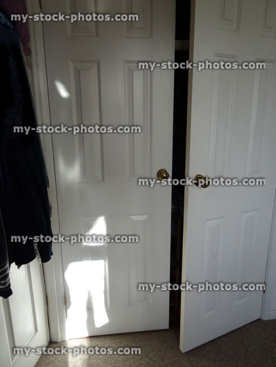 Stock image of built in double wardrobe in bedroom, panelled doors