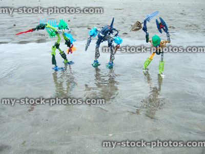 Stock image of strange alien monster figures on a beach