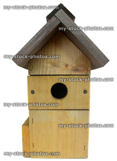 Stock image of wooden bird nest box with small entrance hole