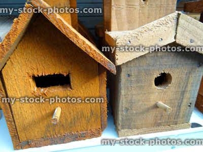 Stock image of wooden nest boxes, birdboxes, bird nesting boxes, perches