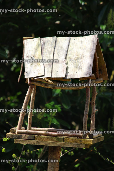 Stock image of rustic birdtable made from reclaimed timber and sticks