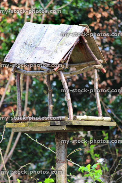 Stock image of homemade wooden birdtable made with branches, reclaimed timber