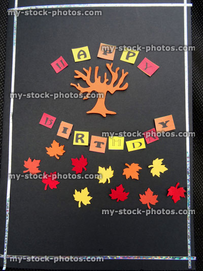 Stock image of homemade Happy Birthday greetings card, paper autumn leaves