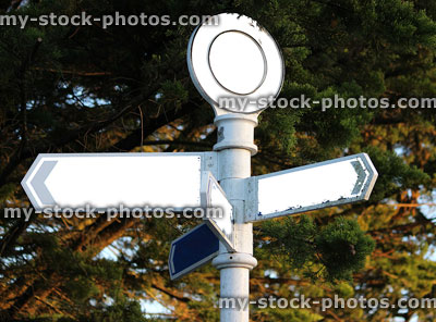 Stock image of blank white signpost with arrows pointing in-all directions