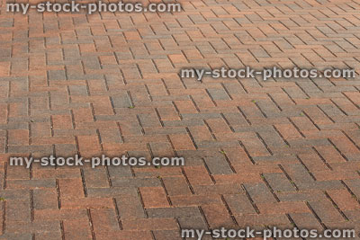 Stock image of red brick paved driveway laid as herringbone pattern