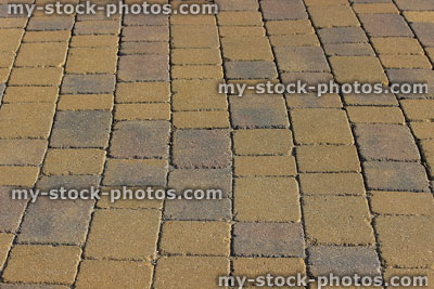 Stock image of grey and gold block paving / paved driveway pattern
