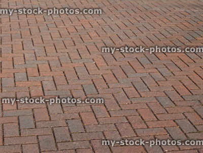 Stock image of recently laid red brick driveway, block paving herringbone pattern