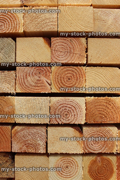 Stock image of wooden fence posts stacked up / square timber pile