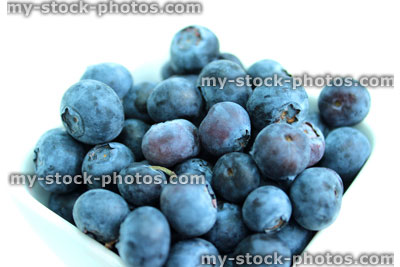 Stock image of dish of organic fresh blueberries, healthy breakfast