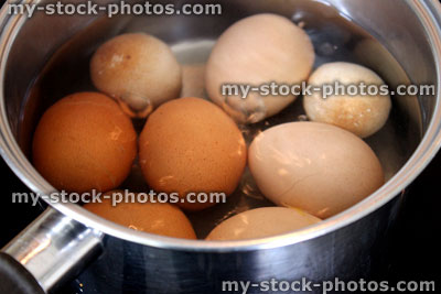 Stock image of chicken eggs boiling in saucepan, boiling water, simmering