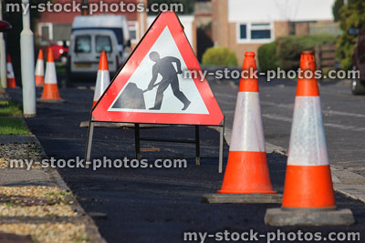 Stock image of building work triangle sign / bollards, freshly laid tarmac pavement