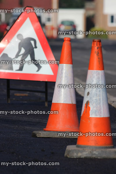 Stock image of red and white traffic cones, warning road sign
