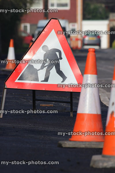 Stock image of triangle road sign with red border, traffic cones / bollards