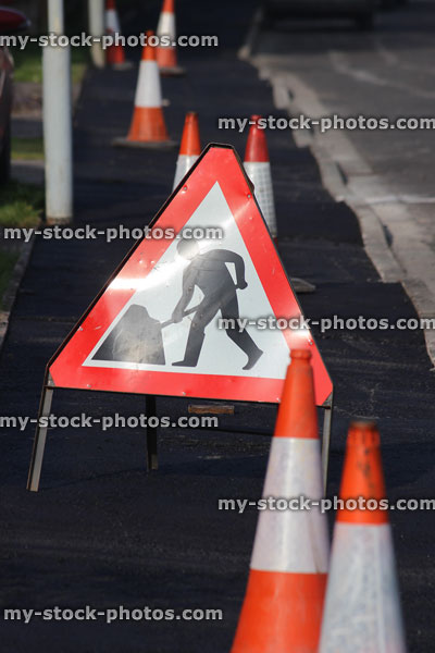 Stock image of Danger Men at Work sign, traffic cones / bollards