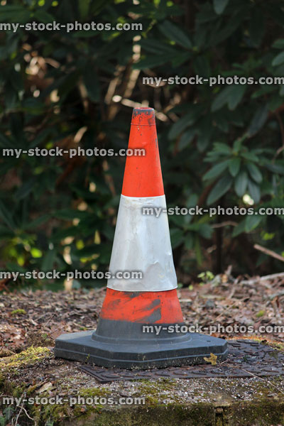 Stock image of red and white bollard, plastic warning traffic cone
