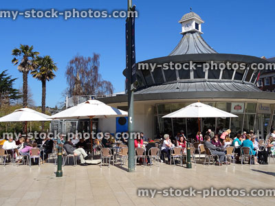 Stock image of crowds enjoying alfresco dining outside pavement cafe with parasols