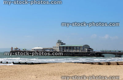 Stock image of historic pier and theatre on beach at Bournemouth