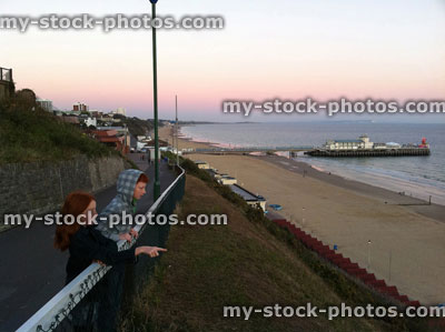 Stock image of young children on Bournemouth cliff at sunset, looking at beach