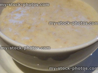 Stock image of freshly made porridge oats, white ceramic bowl, healthy breakfast