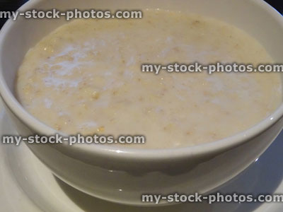 Stock image of freshly made porridge oats, white ceramic bowl, healthy breakfast
